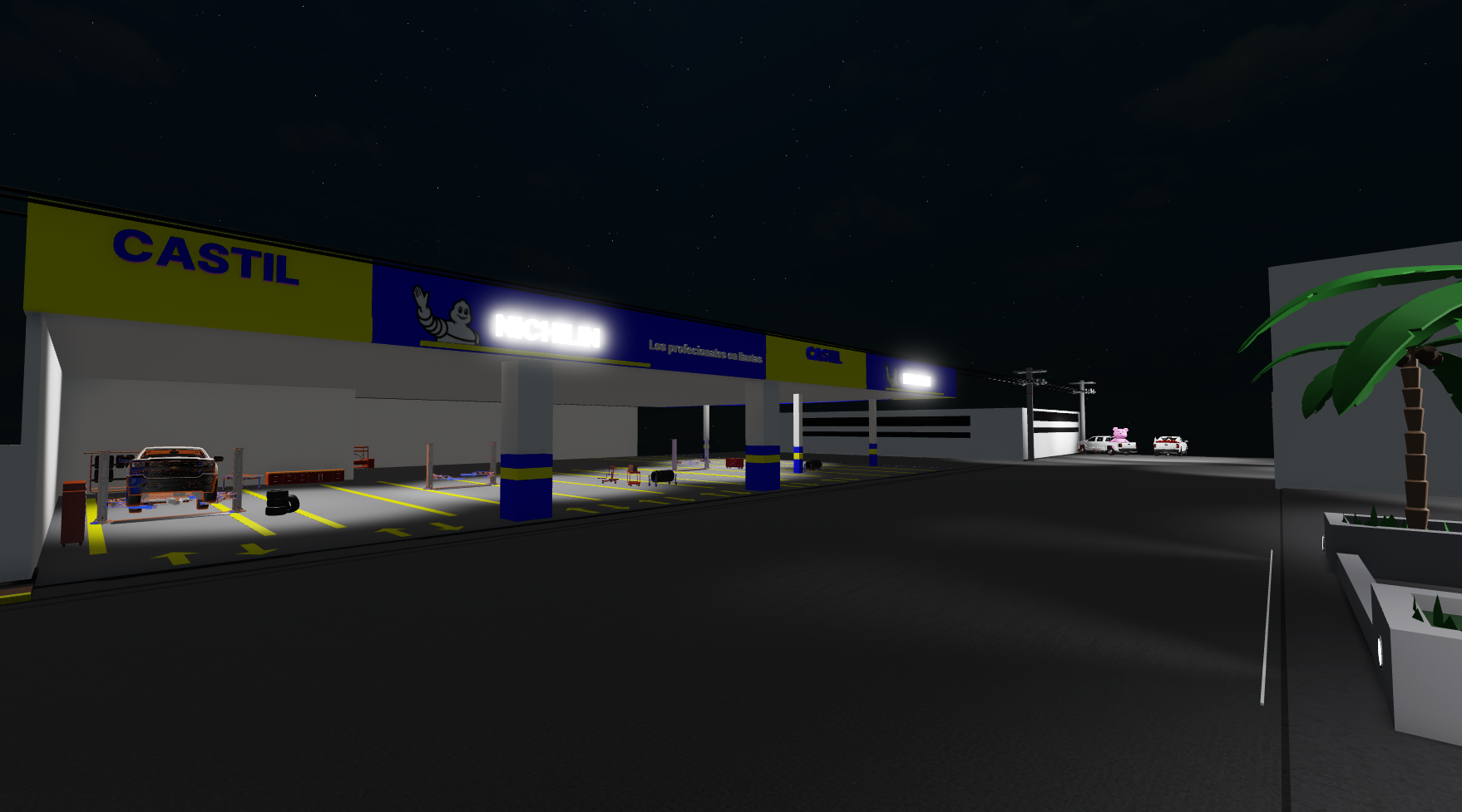 Calle nocturna junto al club y taller de automóviles